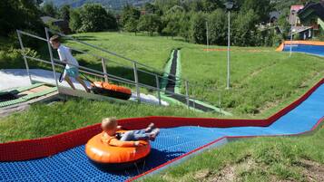 A playground with a slide and a climbing structure.