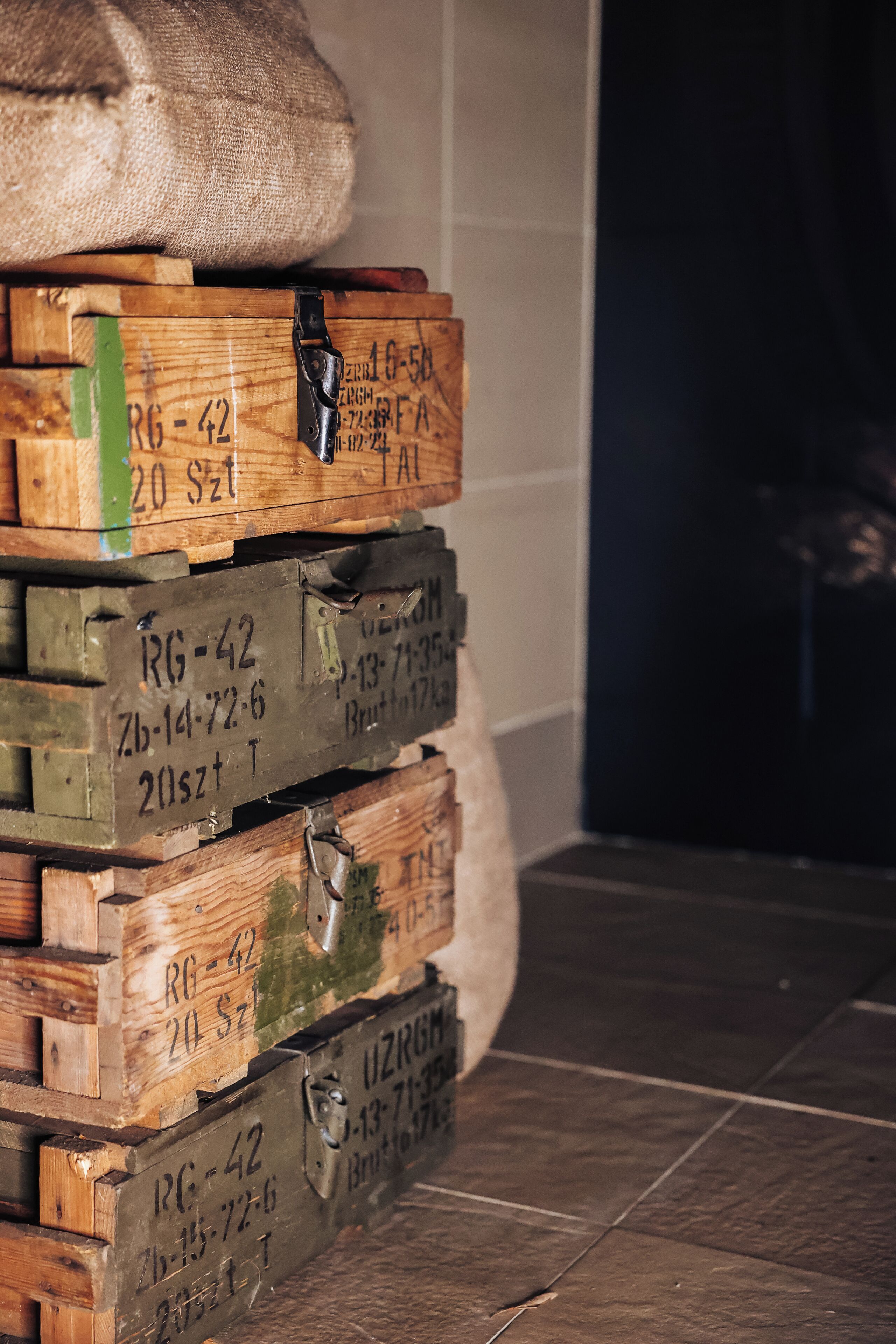 Una pila de cajas de madera con etiquetas y un cierre metálico.