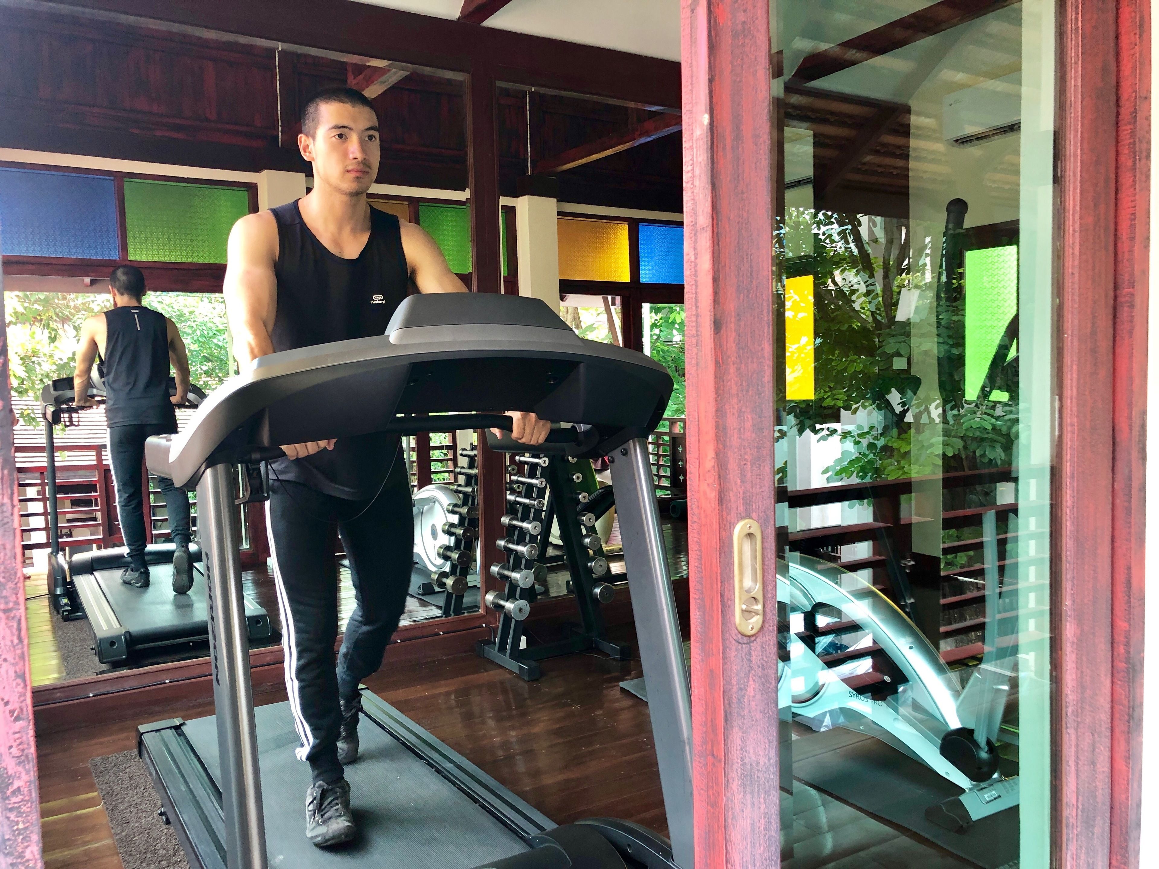 Une salle de sport équipée de tapis de course et d'appareils de musculation.