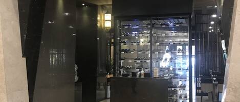A modern interior with a glass display case containing various items.