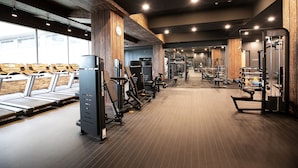 A gym with treadmills, weight machines, and free weights. - Hotel International (Changwon)
