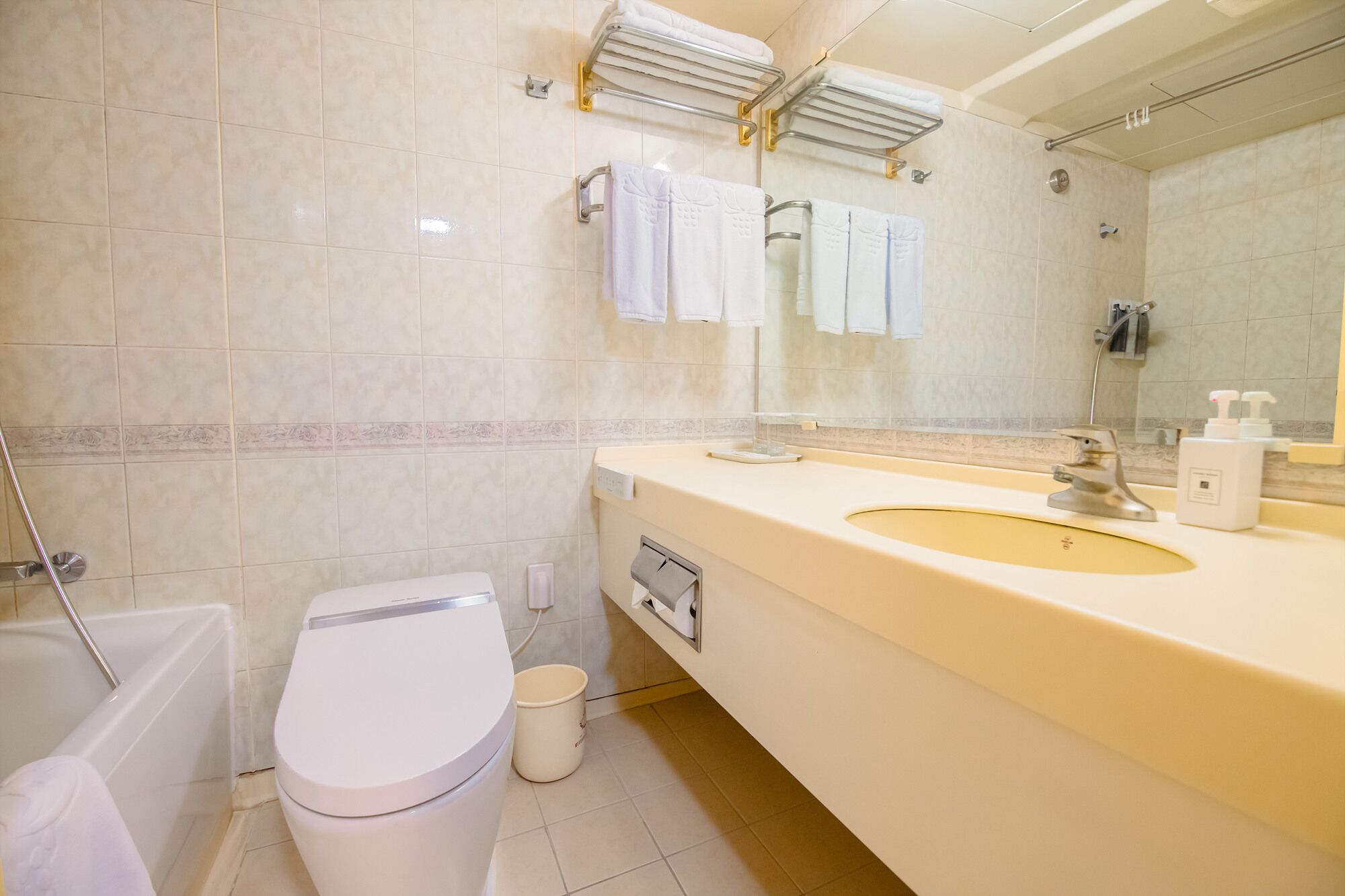 A modern bathroom with a toilet, sink, and shower.