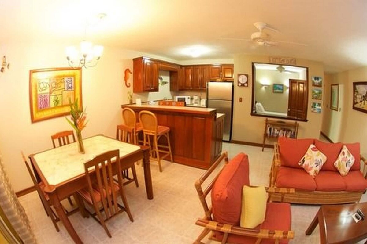 A compact living space with a dining area, kitchen, and seating area.
