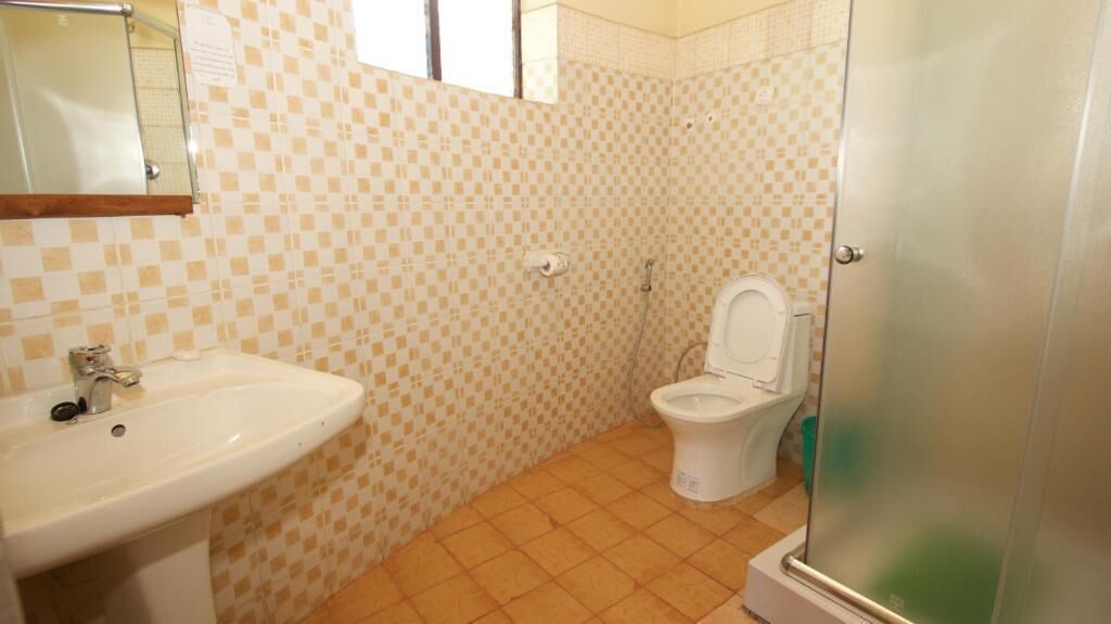 A bathroom with a sink, toilet, and shower.