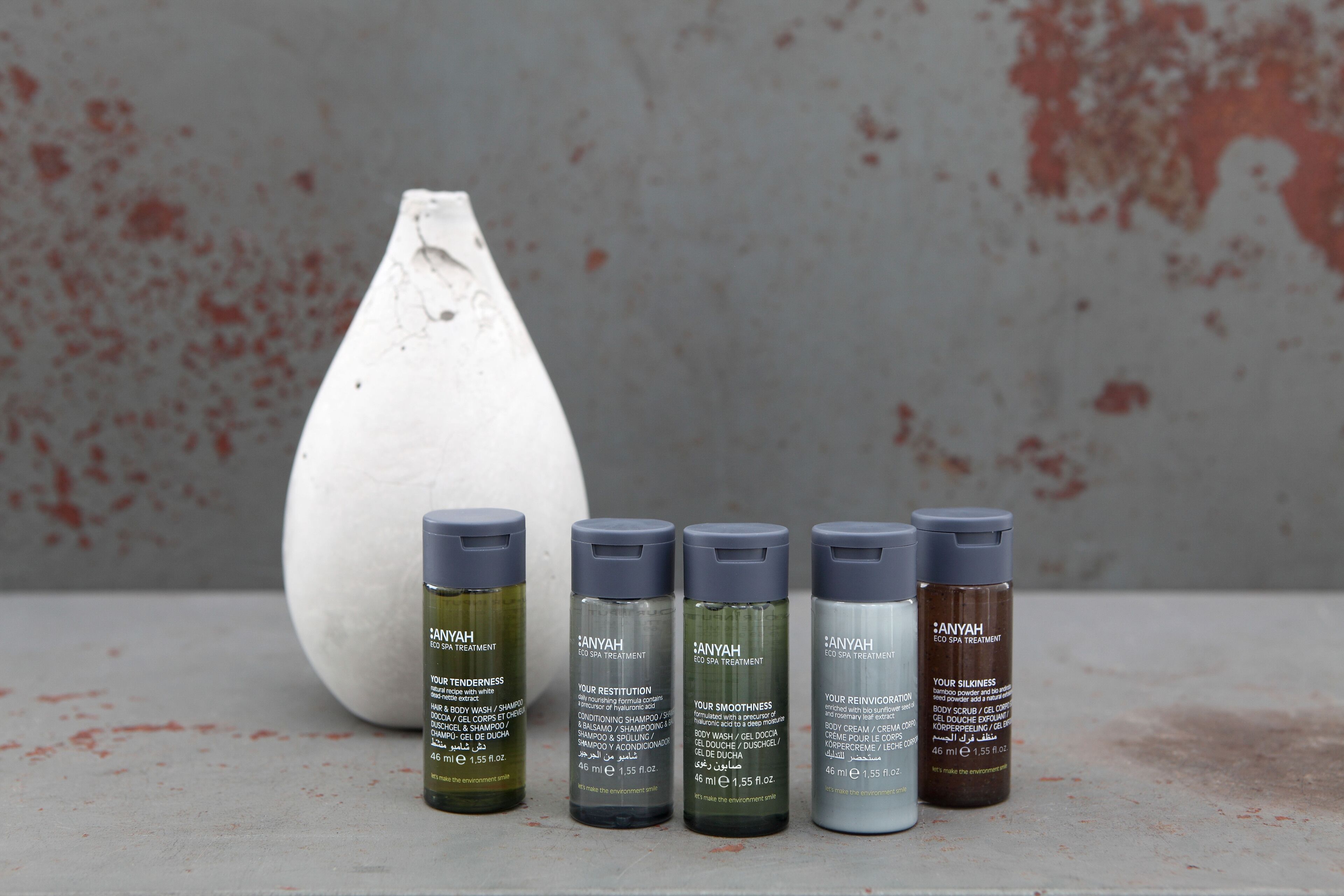 A row of skincare bottles labeled 'ANYAH' with different product names like 'TENDERNESS', 'RESTITUTION', 'SMOOTHNESS', 'REINVICTION', and 'SLIKNESS'.