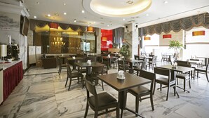 A restaurant with marble flooring, wooden tables and chairs, and a central chandelier. - Metro Tourist Hotel (Cheonan)