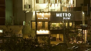 A hotel with a prominent "METRO Hotel" sign, multiple balconies, and a traditional architectural style. - Metro Tourist Hotel (Cheonan)