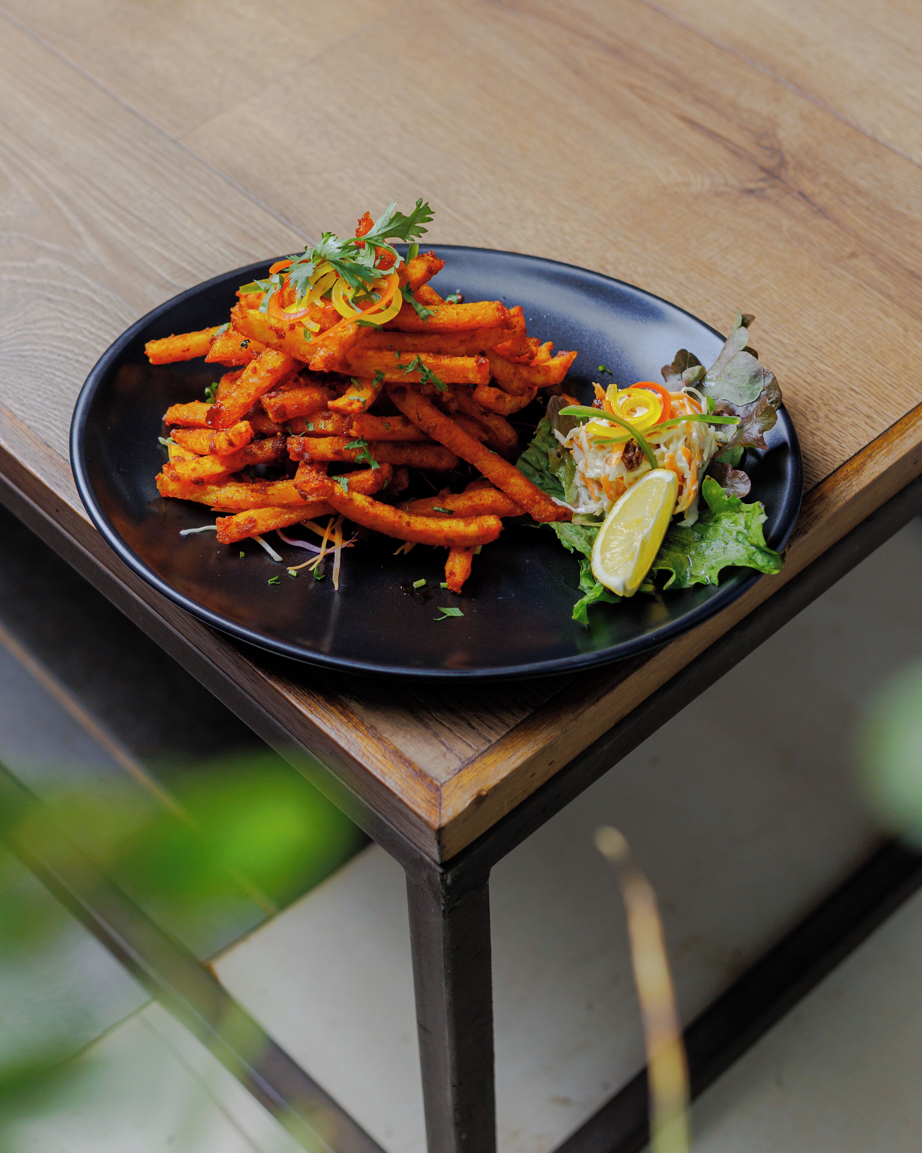 A plate of food on a wooden table.