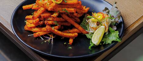A plate of food on a wooden table.