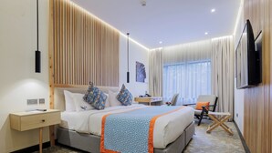 A modern hotel room with a large bed, bedside tables, a desk, and a TV. - PrideInn Westlands Luxury Boutique Hotel (Nairobi)