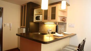 Fridge, microwave, espresso maker, cookware/dishes/utensils