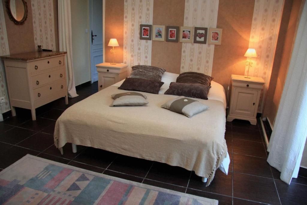 A bedroom with a bed, two bedside tables, a dresser, and a rug.