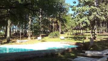 Outdoor pool, a natural pool, pool umbrellas, sun loungers