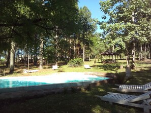 Outdoor pool, a natural pool, pool umbrellas, sun loungers