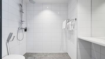 A modern bathroom with a shower, toilet, and a towel rack.