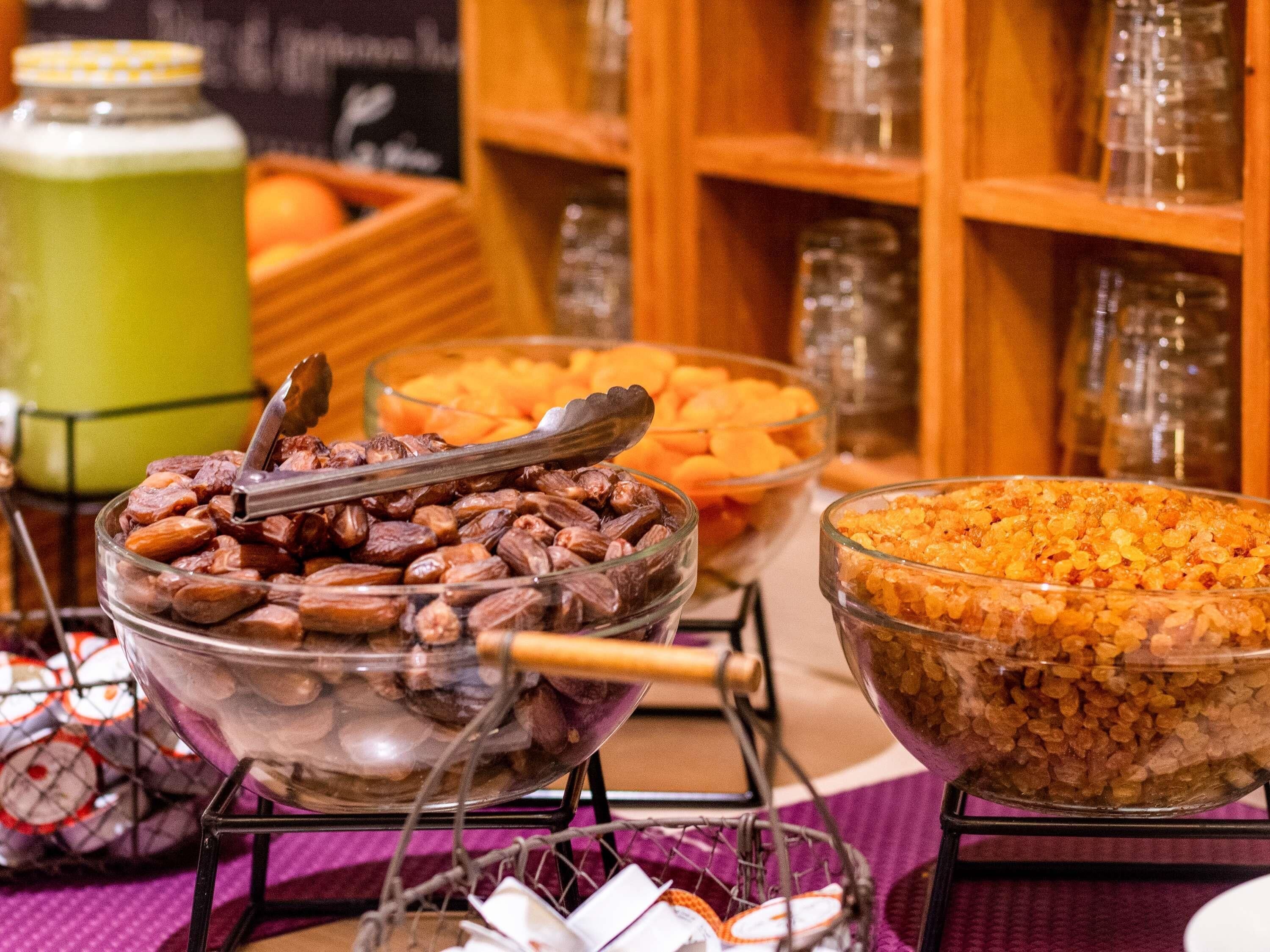 A buffet with various food items in clear glass bowls.