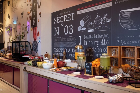 A breakfast buffet area with a chalkboard menu, various food items, and a coffee machine. - ibis Tanger City Center (Tangier)