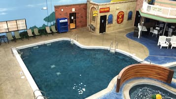 An indoor swimming pool with a lifeguard stand, a play area, and a children's playroom.