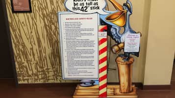 A waterslide safety rules sign with a height requirement of 42 inches.