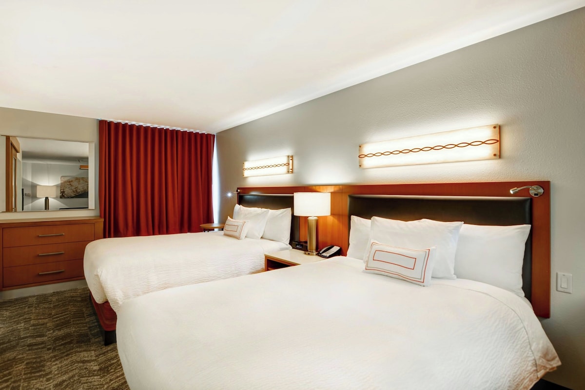 Premium bedding, desk, laptop workspace, blackout curtains