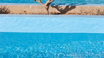 Seasonal outdoor pool, open 10:30 AM to 6:30 PM, pool umbrellas