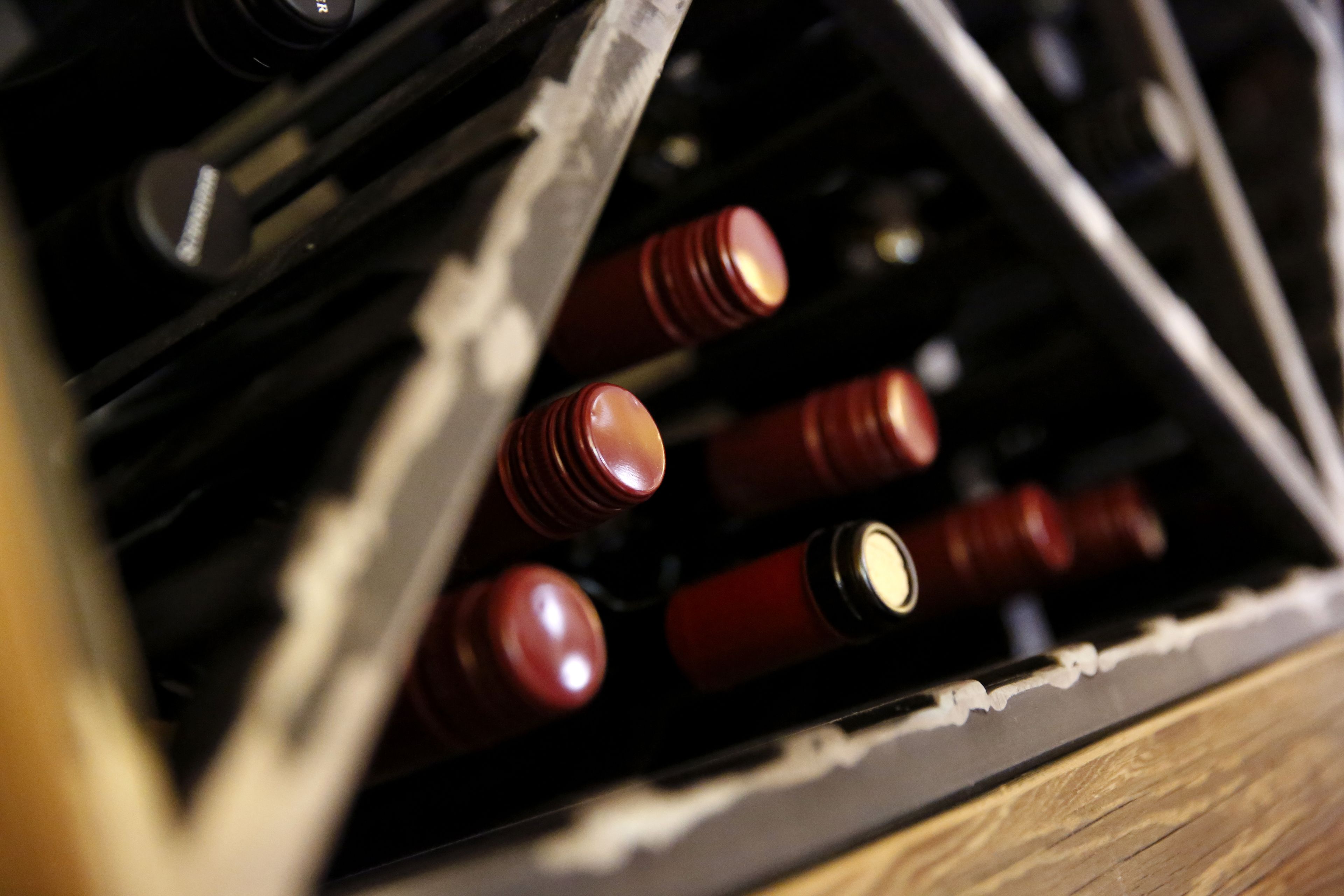 A close-up of wine bottles in a wooden crate.