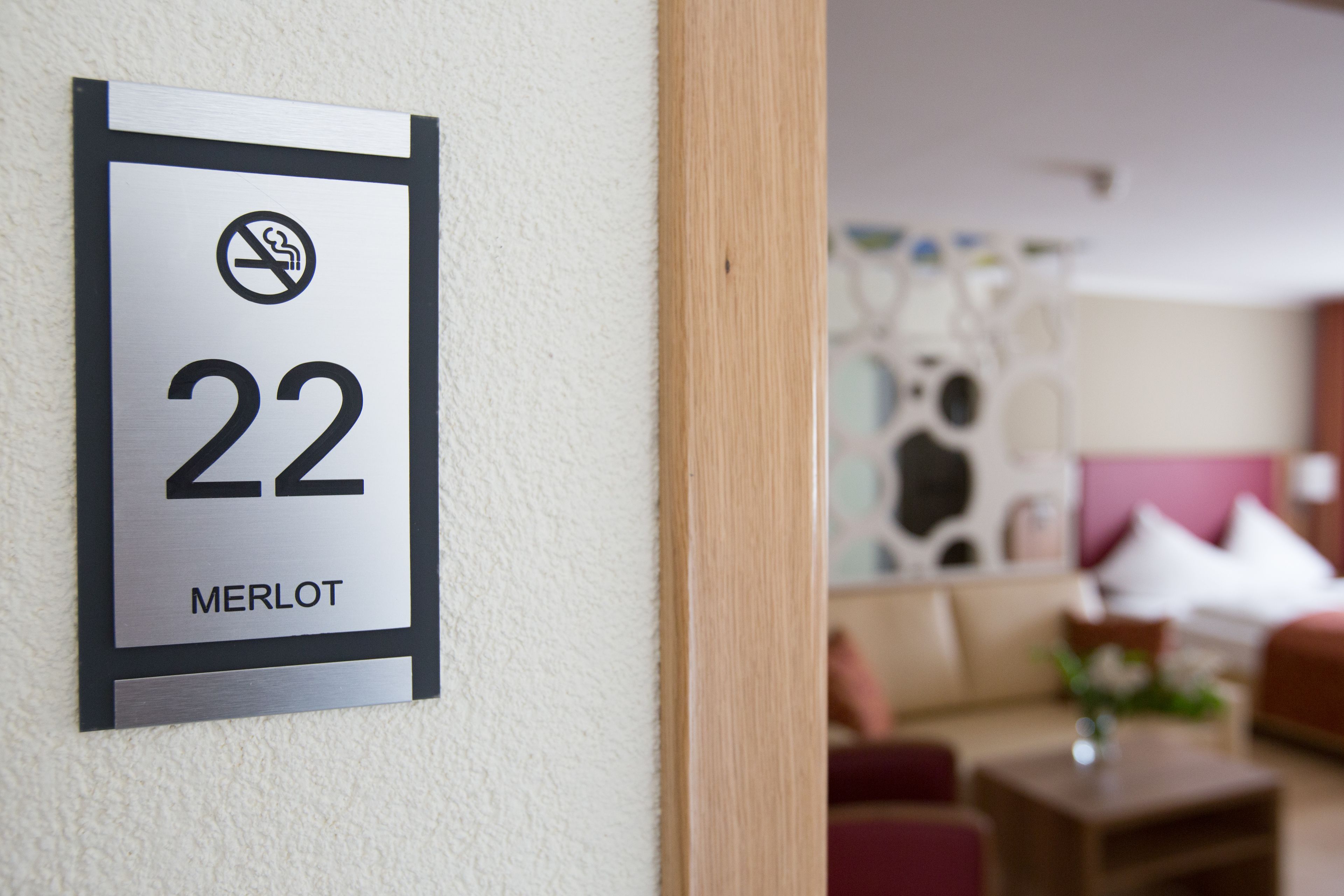 A hotel room number sign with a no-smoking symbol and the number 22.