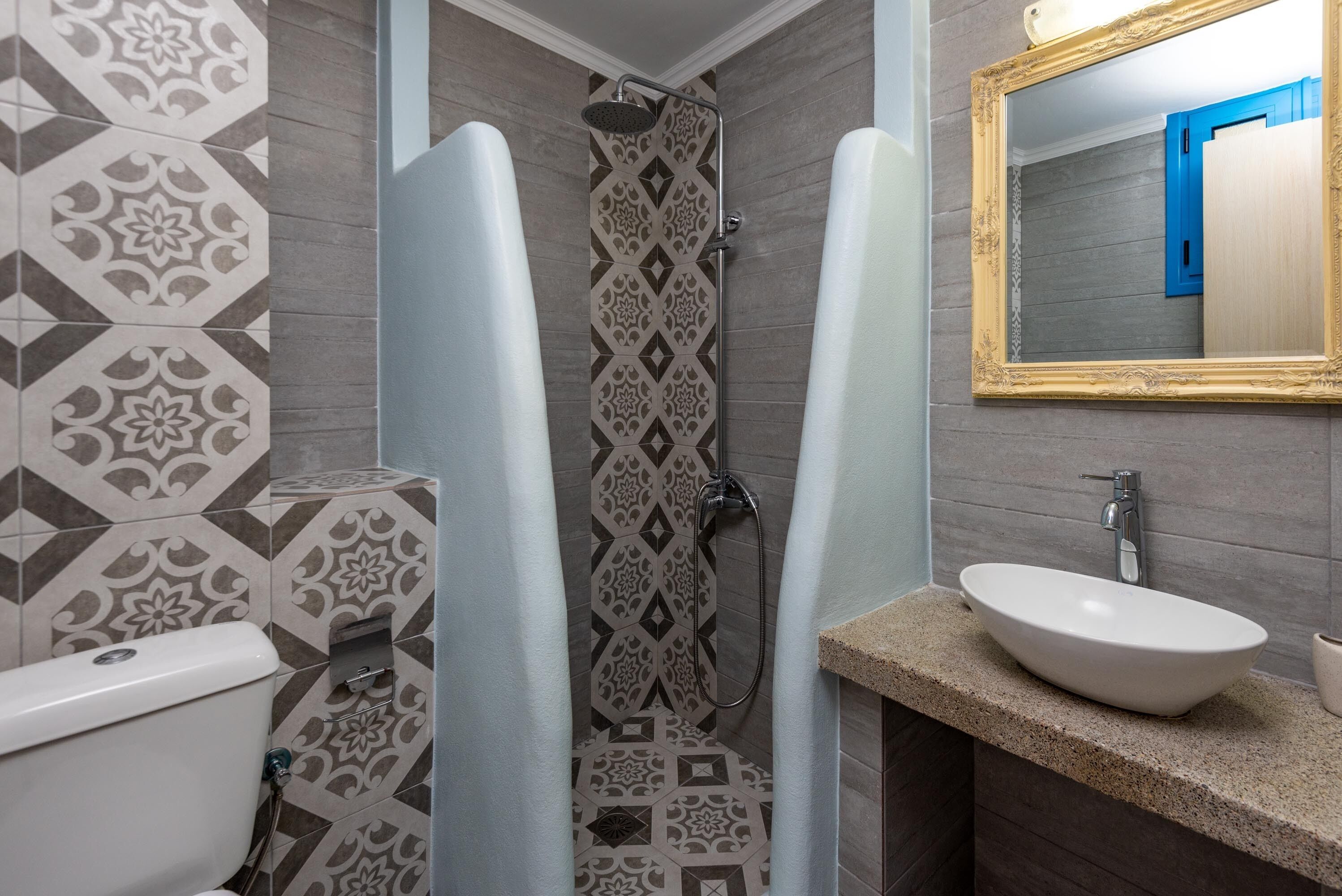 A bathroom with a shower, toilet, and sink.