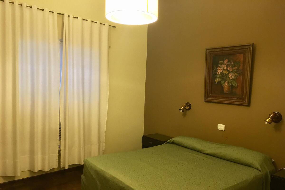 Premium bedding, desk, laptop workspace, blackout drapes