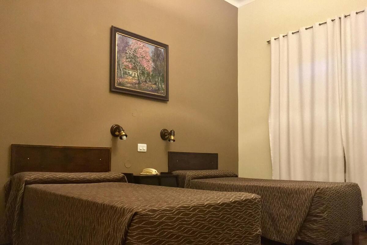 Premium bedding, desk, laptop workspace, blackout drapes