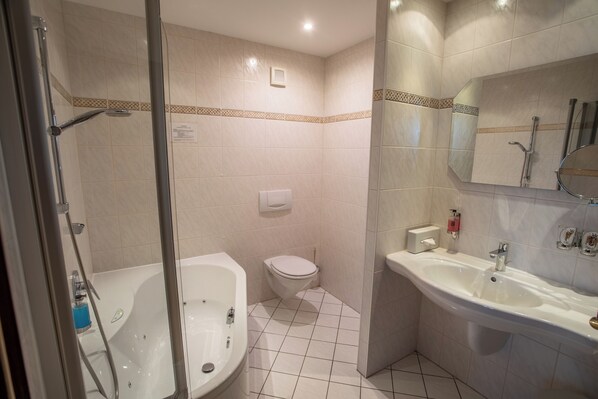 A bathroom with a bathtub, toilet, and sink.