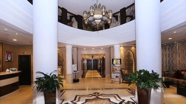 A spacious lobby with a high ceiling, a chandelier, and a patterned floor. - AlHamra Hotel (Sharjah)
