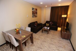 Deluxe Suite, Garden View | Living room | LCD TV - AlHamra Hotel (Sharjah)