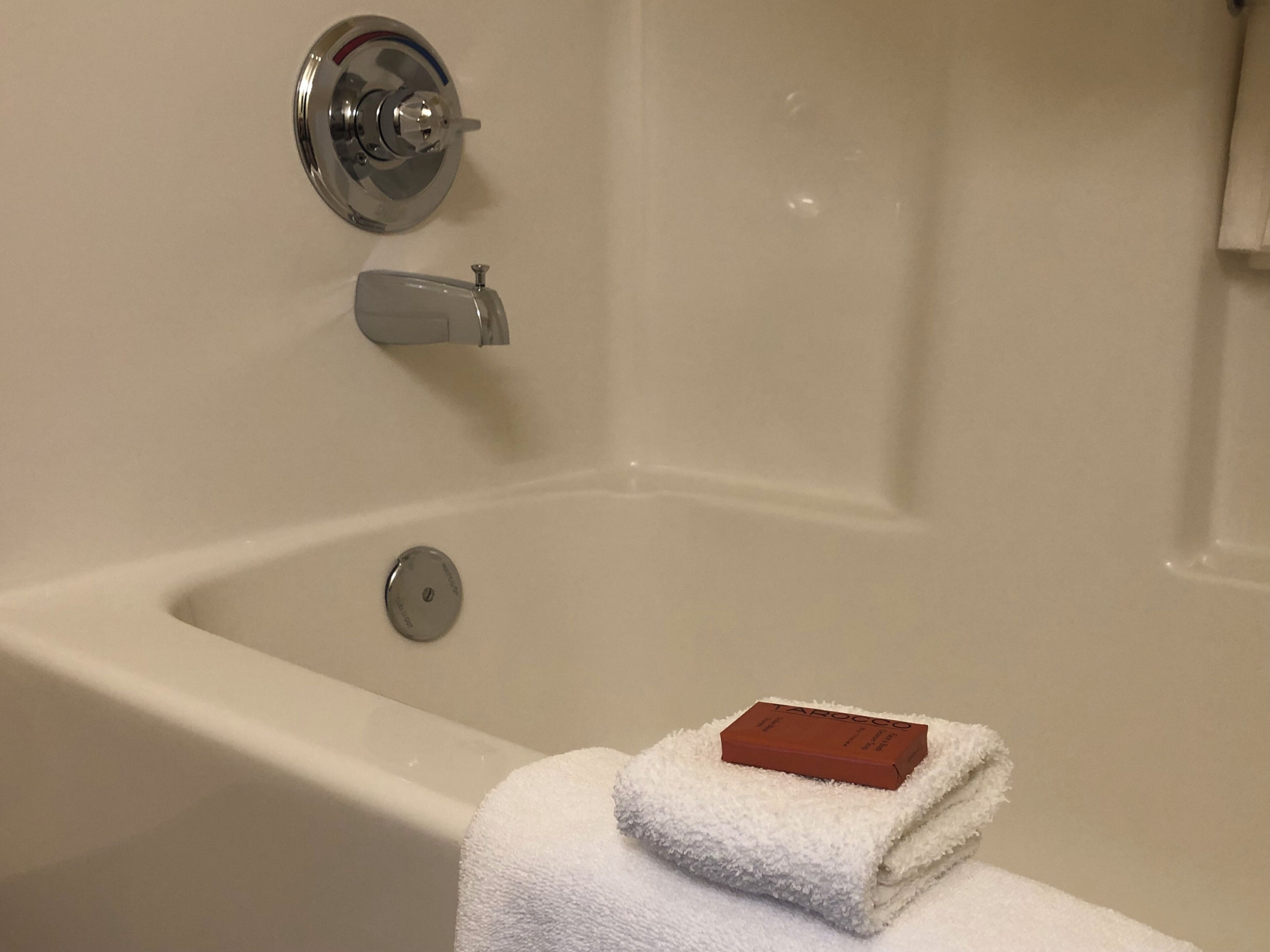 A bathtub with a faucet and a soap dish.