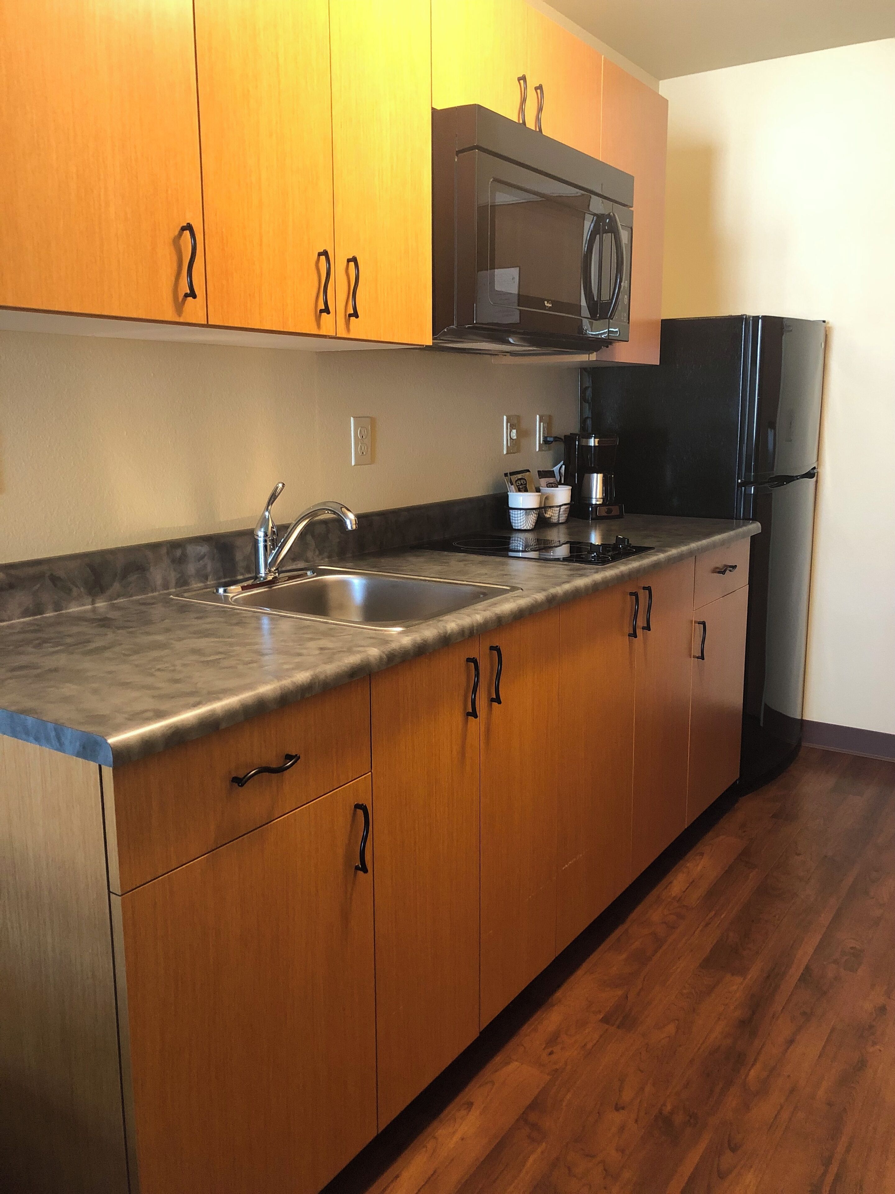 fridge, microwave, coffee/tea maker, cookware/dishes/utensils