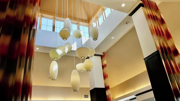 A modern interior with hanging pendant lights and a staircase.