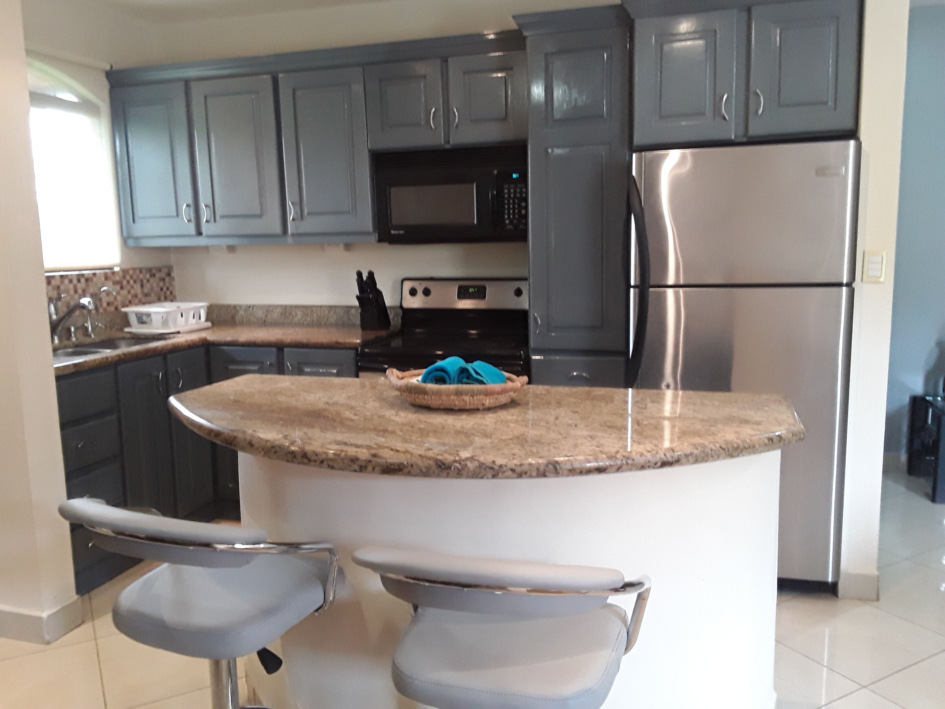 coffee/tea maker, cleaning supplies, freezer, dining tables