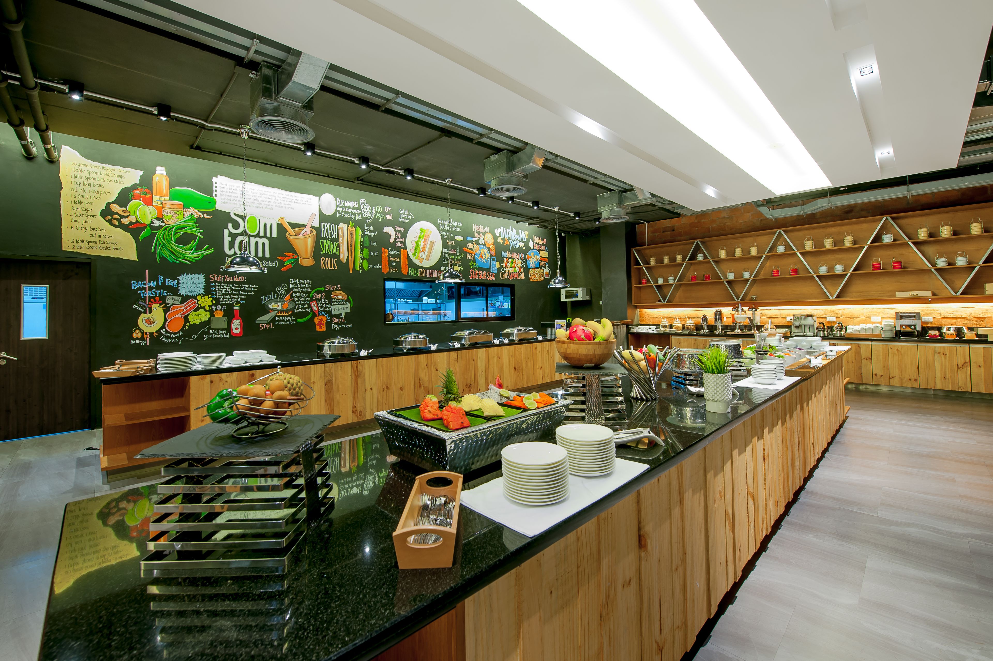 A buffet area with a variety of food items and a chalkboard menu.