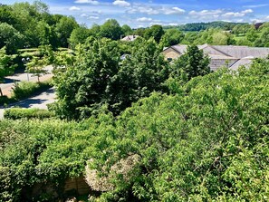 A lush green landscape with dense foliage and a few buildings in the background. - The Old Station House - B&B (Matlock)