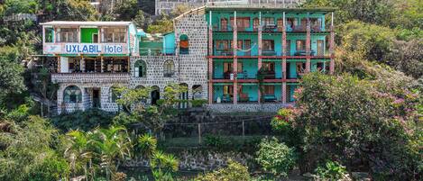 A hotel with multiple floors, a stone facade, and balconies.