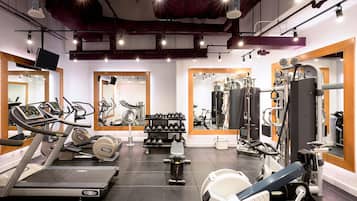 A gym with treadmills, weight machines, and free weights.