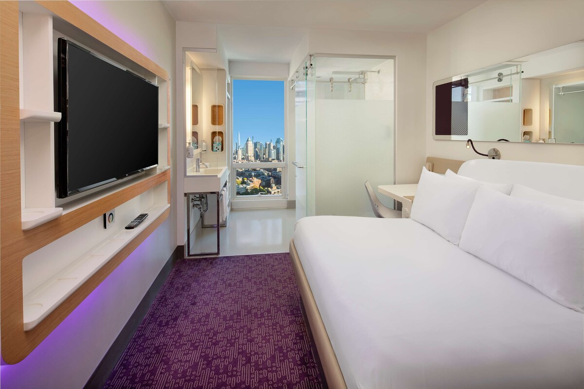Skyline View | In-room safe, desk, laptop workspace, blackout curtains
