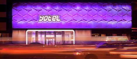 A hotel with a distinctive purple facade and a clear entrance.