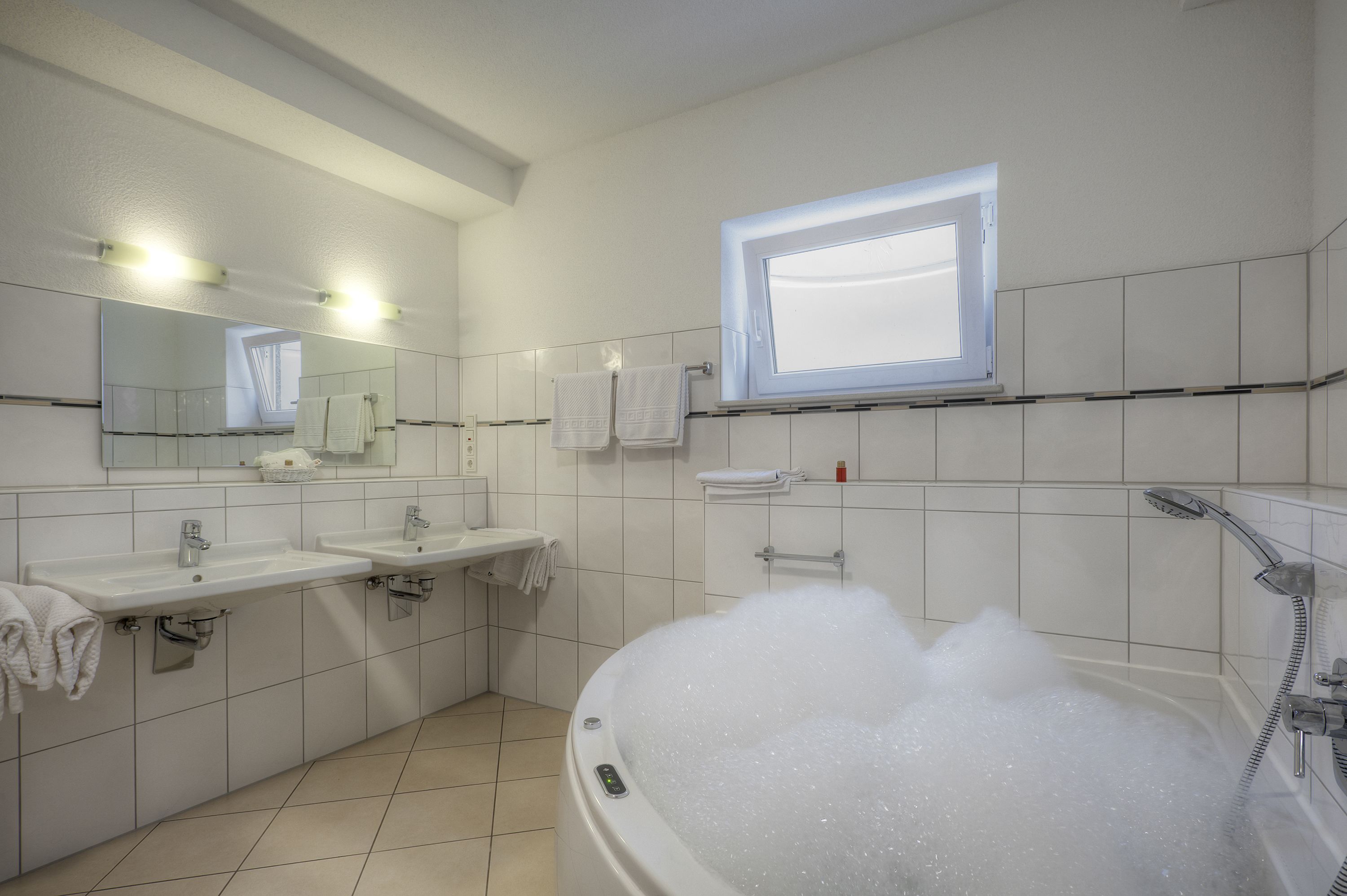 luxury suite, jetted tub | bathroom | free toiletries, hair dryer, bathrobes, slippers