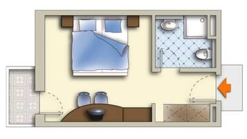 A hotel room layout with a bed, two bedside tables, a small bathroom with a sink and toilet, and a kitchenette area.