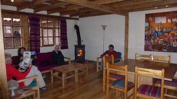 A cozy room with wooden furniture, a fireplace, and a painting on the wall.