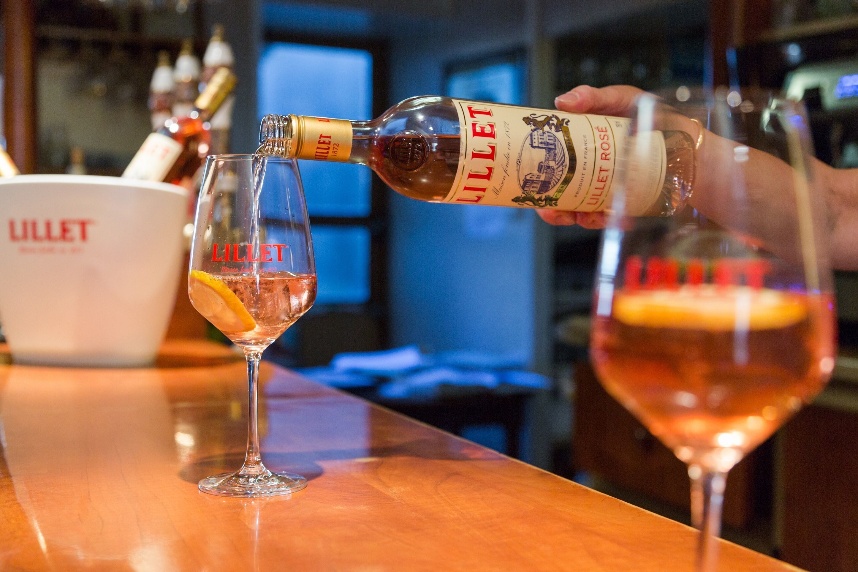 A bottle of Lillet being poured into a glass.