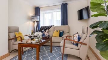 Standard Apartment, 2 Bedrooms | Living area | 32-inch TV with cable channels, DVD player