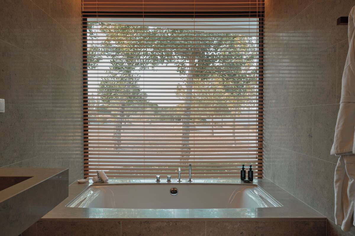 premier studio suite | bathroom | separate bathtub and shower, hair dryer, slippers, towels