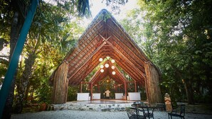 A thatched-roof pavilion with a central altar, surrounded by seating and a gravel area. - Amarte Maroma Hotel Eco Boutique Spa (Playa del Carmen)